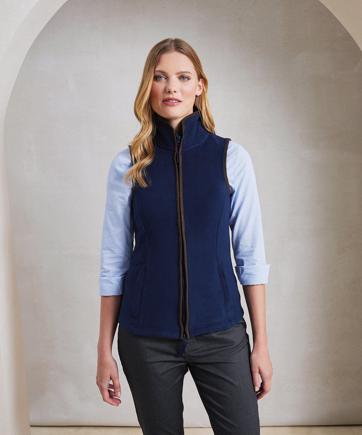 Model wearing the PR804 Women’s Artisan Fleece Gilet in Navy, showing the tailored fit for a professional hospitality uniform.