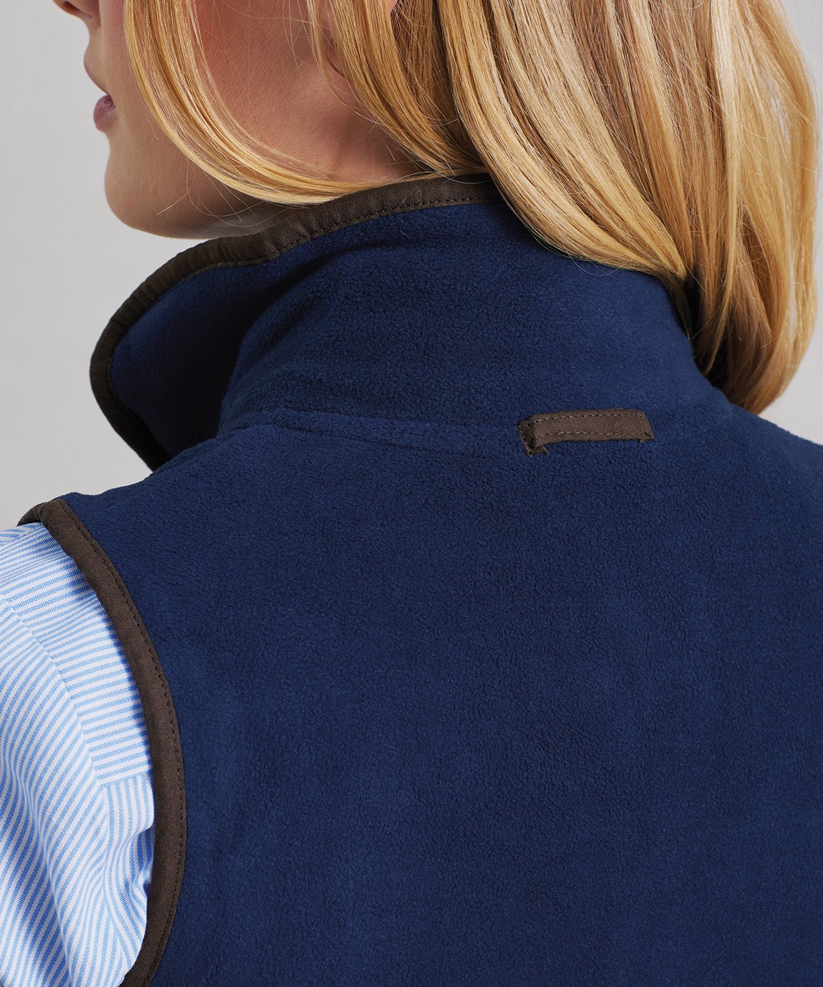 Close-up of the PR804 Women’s Artisan Gilet back neck showing the tag-free area for easy custom branding and private labeling.