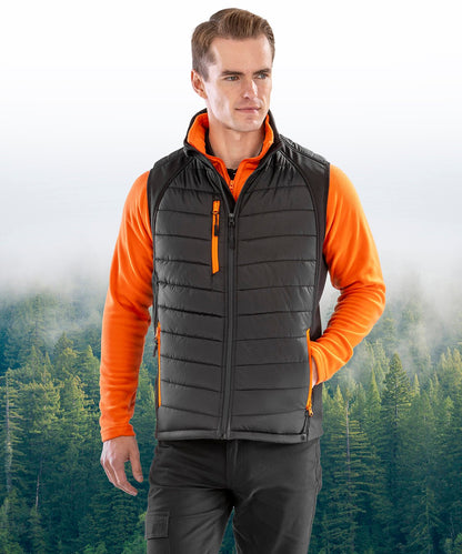 Man wearing the R238X in Black with Orange Zippers demonstrating the stretch fabric designed for active movement and comfort.