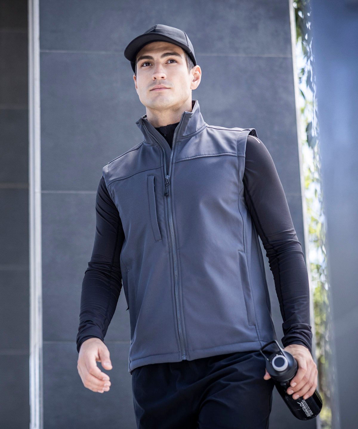 Model wearing the RG154 Flux gilet in a outdoor environment, demonstrating its windproof and water-resistant capabilities.