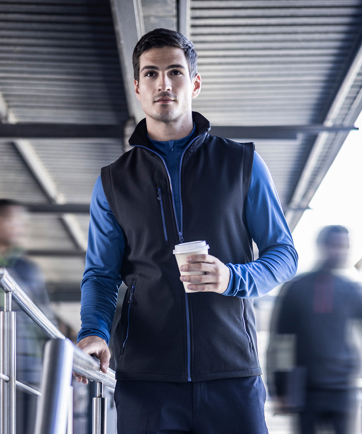 Model wearing the RG595 Navigate softshell vest, highlighting the lightweight design and professional uniform look.